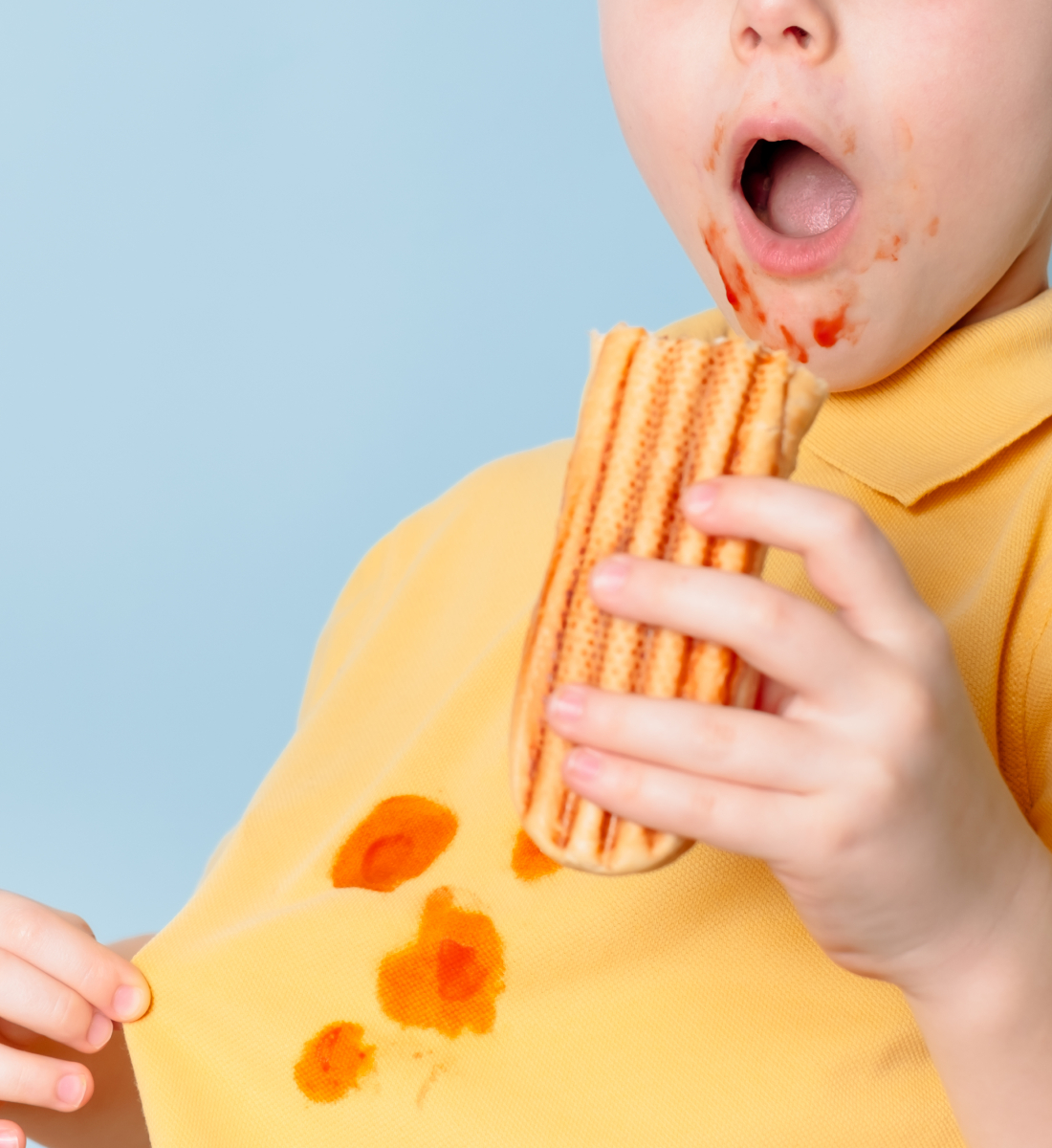 Child spilling condiment on their shirt